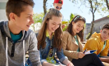 education-high-school-people-concept-group-happy-teenage-students-with-notebooks-learning-campus-yard