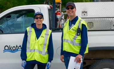 Happy Town staff members in yellow safety vests working at the annual parade