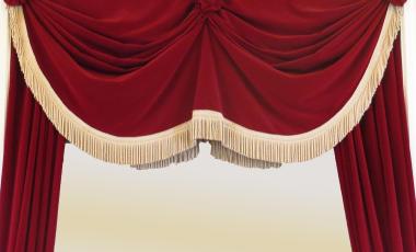 A red curtain over a theatre stage.