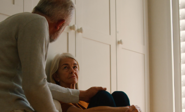 Two seniors share an intimate conversation in their home