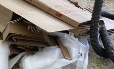 construction materials and trash lay in a pile