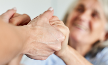 supportive hand holding seniors 