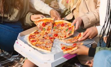 close-up-take-away-pizza-teenagers-hands