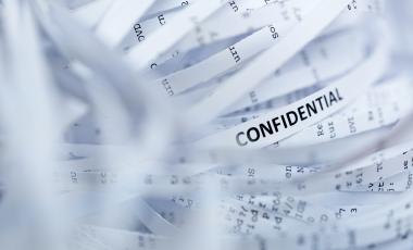 shredded documents with the word confidential on it