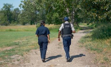 Two peace officers walking in park