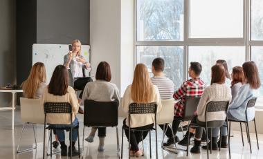 teaching young people in office