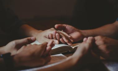 Holding hands over a book
