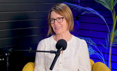 Mayor Thorn smiling in front of a podcast mic