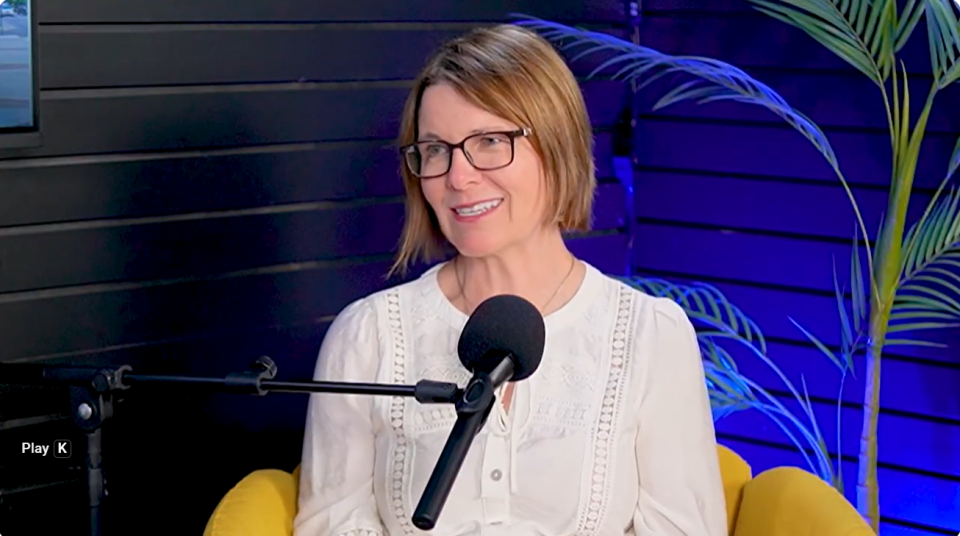 Mayor Thorn smiling in front of a podcast mic