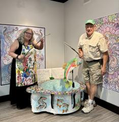 two artists stand in a studio