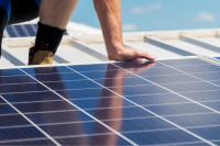 man on roof installing solar panels