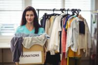 female-volunteer-holding-clothes-donation-box-to-swap-or-donate