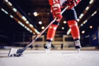 close-up-hockey-player-skating-with-stick-puck