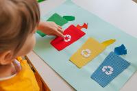 Child with craft on organics waste sorting
