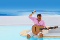 the artist PAVLO in a pool with his guitar