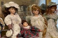 Old dolls on display on an old childs dresser 