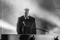 a man plays piano in a smoky moody bar