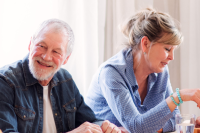 four older adults engaging in conversation and laughing