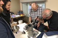 volunteer fixers repairing a mixer