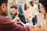 multiracial-group-people-african-american-woman-sitting-registration-table-filling-out-ballot
