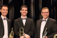 Five brass band members standing in tux