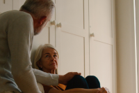 Two seniors share an intimate conversation in their home