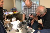 Repair Cafe volunteers fixing house appliance
