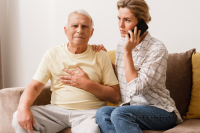 woman calls someone while supporting older male adult 