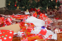 wrapping paper spread on the ground around a christmas tree