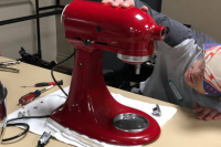 A man repairs a mixer at a repair cafe