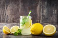 Lemonade drink in a jar glass on wooden background
