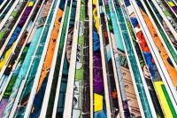 Stack of old comic books creates colorful background texture