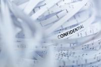 shredded documents with the word confidential on it