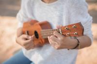 Young woman playing on Ukulele