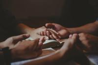Holding hands over a book
