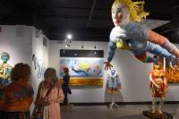 an art gallery with lifesized artwork