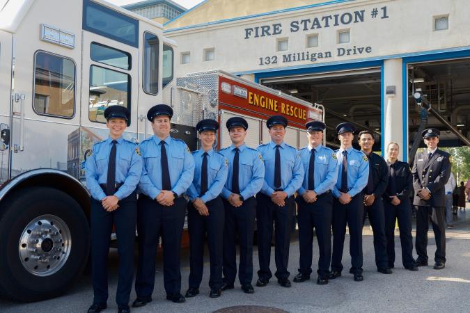 nine of the newest fire and rescue recruits standing in front of fire and rescue truck