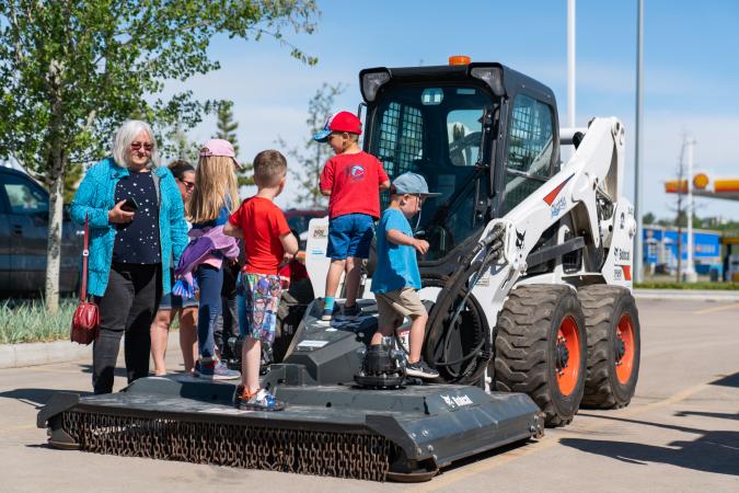 families looking at a construction bobcat
