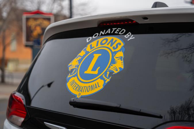 Back of transit van with Okotoks Lions Club logo