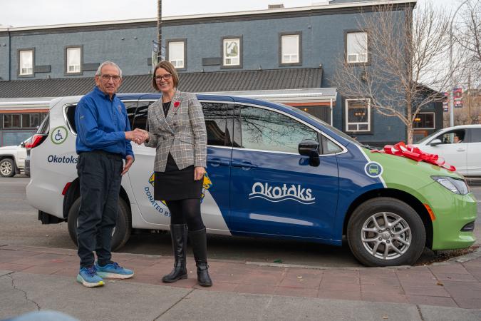 Mayor Thorn and Okotoks Lions Club president Stewart Thomas in front of new transit van donated by the Lions Club
