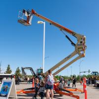 a crane extends with familes watching 