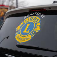 Back of transit van with Okotoks Lions Club logo