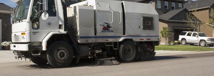 Street cleaning equipment in use in a residential area in Okotoks. 