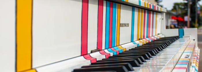 painted piano outdoors in Okotoks with close up of piano keys