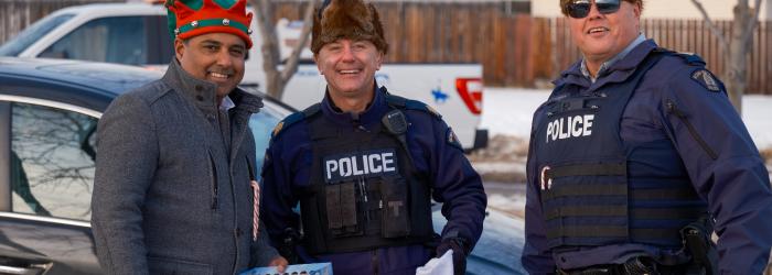 Okotoks Municipal Enforcement and Okotoks RCMP members posing at the Charity Checkstop 