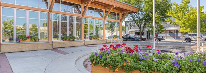 Okotoks Municipal Centre in summer with flowers blooming out front