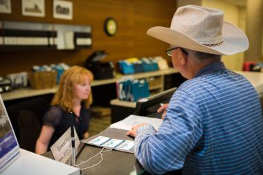 Resident being helped at front counter with customer service at municipal centre