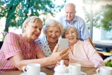 Group of smiling seniors take selfie photo