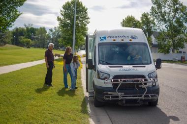 People waiting to get on Okotoks transit vehicle