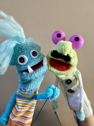 Two hand and rod puppets with big googly eyes and fangs. 